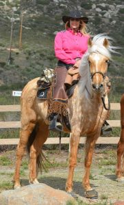 Image of Jody Childs on her horse while wearing Cavllo Sport Hoof boots and a Cavallo Saddle Pad.